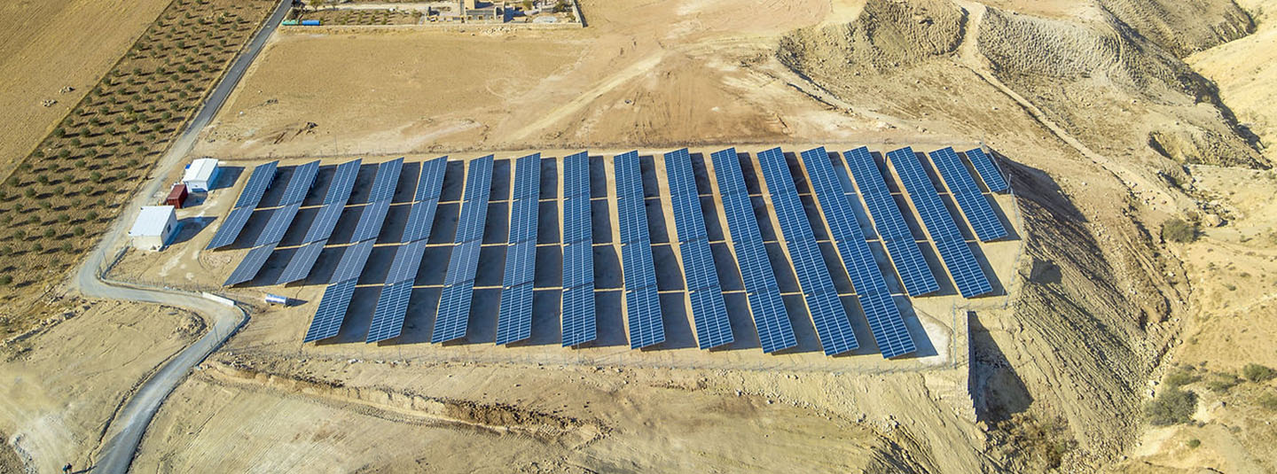 A large solar panel array on an arid plateau