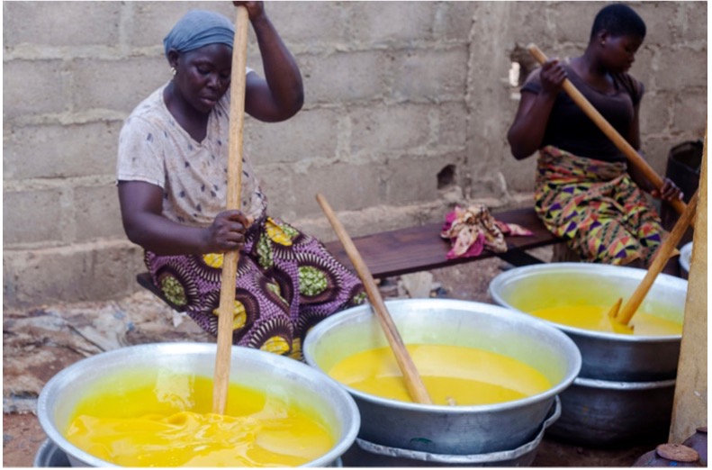Women melting and processing shea butter