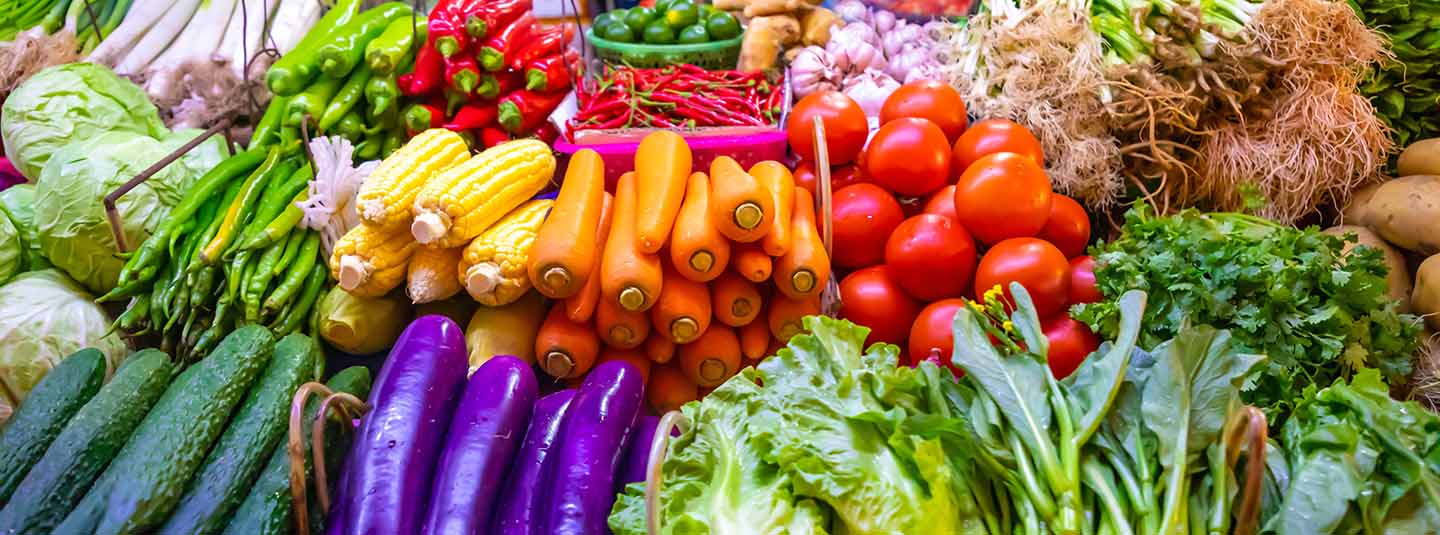 Variety of fresh, colorful vegetables on a table in a market