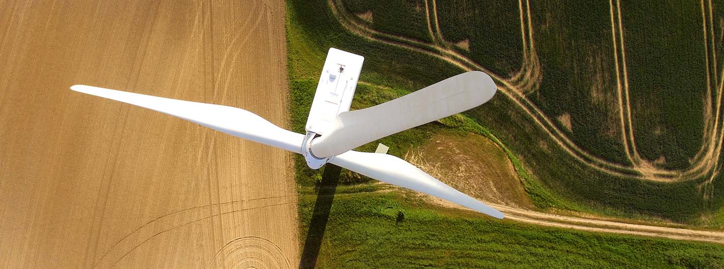 Aerial view of a wind turbine in an agricultural field