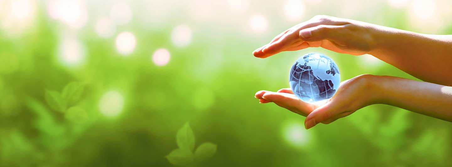 Hands holding a small blue globe